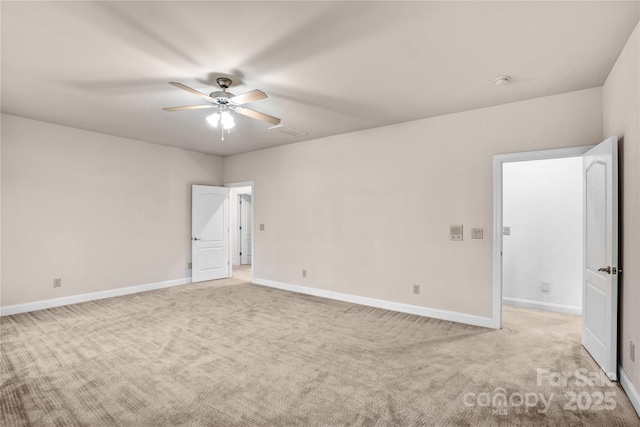 empty room with baseboards, light colored carpet, and ceiling fan