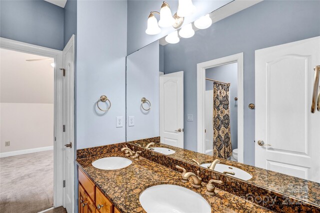 full bathroom with a shower with shower curtain, toilet, and a sink