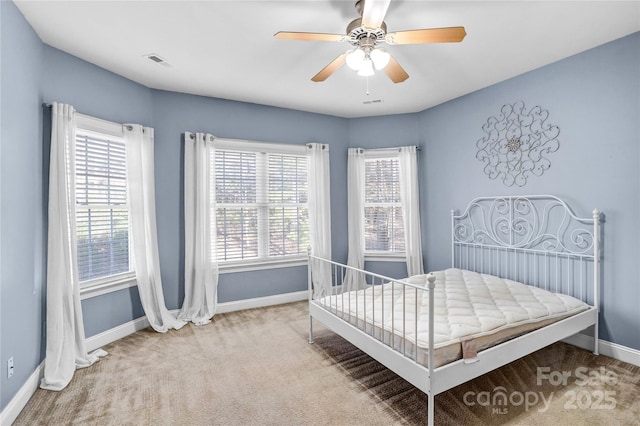 bedroom featuring visible vents, carpet floors, baseboards, and a ceiling fan