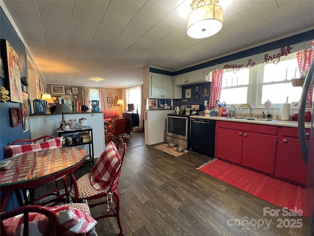 kitchen featuring stainless steel range with electric stovetop, black dishwasher, red cabinetry, and dark wood finished floors