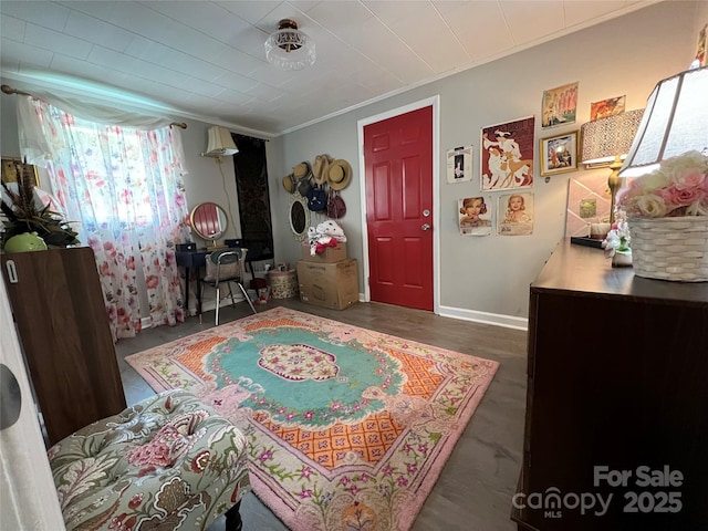 interior space with wood finished floors and crown molding