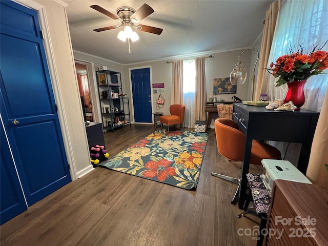 interior space with ornamental molding, ceiling fan, baseboards, and wood finished floors