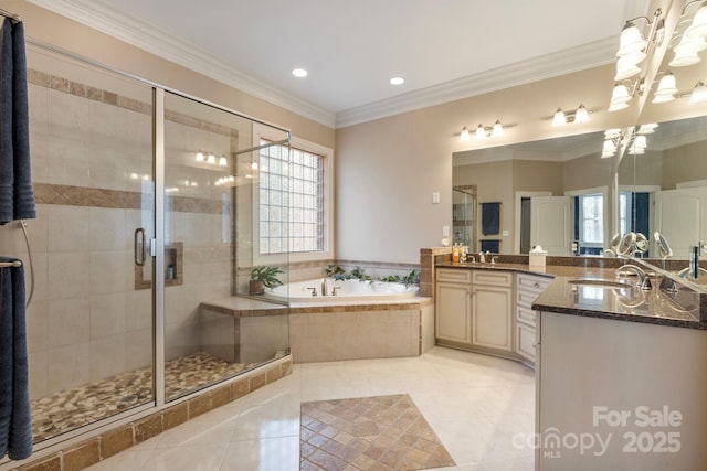 full bathroom with a garden tub, crown molding, a shower stall, and a sink