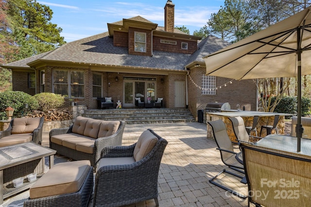 view of patio featuring an outdoor living space, area for grilling, and a grill