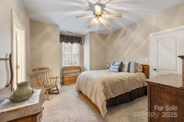 bedroom with ceiling fan and light carpet