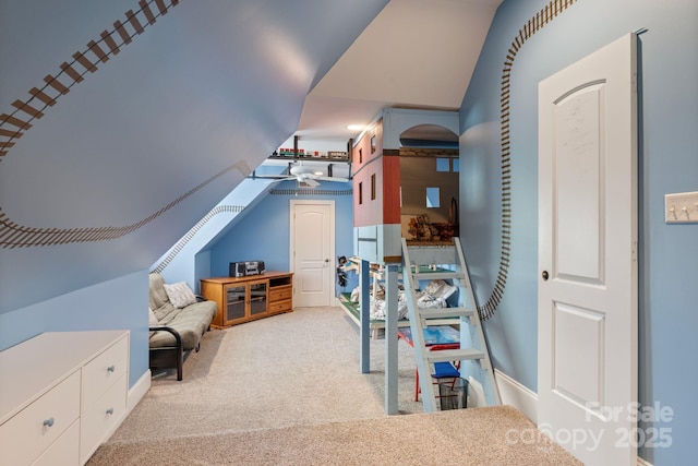 bedroom featuring lofted ceiling and carpet