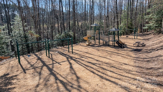 community playground featuring a forest view