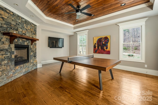 14 Twinflower Trl, Asheville, NC 28804 - playroom featuring baseboards, a stone fireplace, crown molding, a raised ceiling, and wooden ceiling