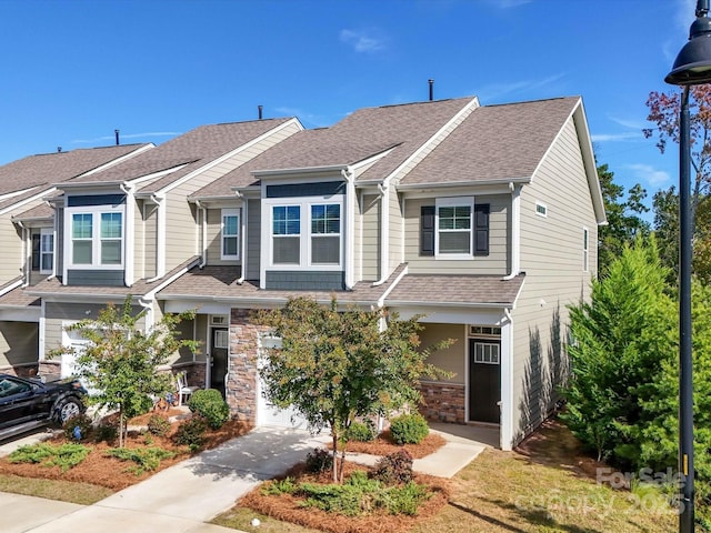 multi unit property with stone siding and roof with shingles