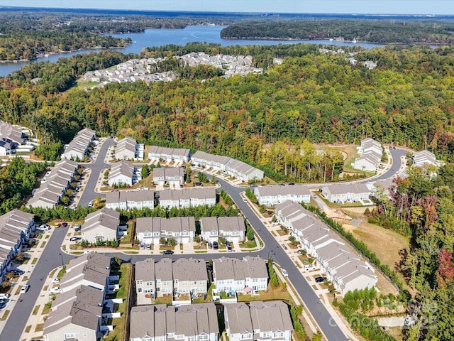 aerial view featuring a water view, a residential view, and a view of trees