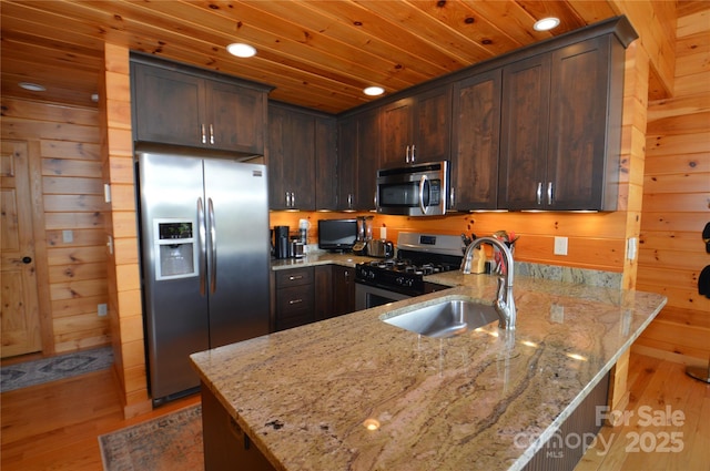 kitchen featuring a sink, wood ceiling, dark brown cabinets, appliances with stainless steel finishes, and light stone countertops