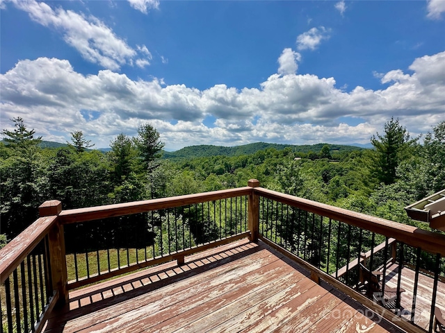 wooden deck featuring a forest view