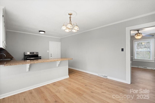 kitchen with light stone counters, light wood-style flooring, visible vents, ornamental molding, and stainless steel electric range