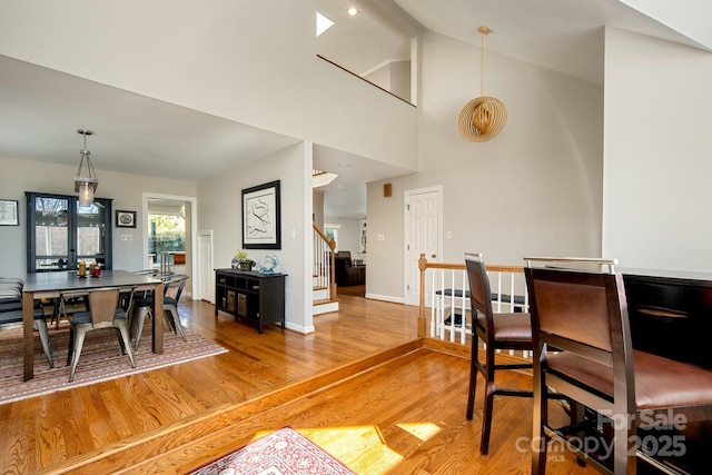 205 Midland Dr, Asheville, NC 28804 - dining space with high vaulted ceiling, stairway, light wood finished floors, baseboards, and beamed ceiling