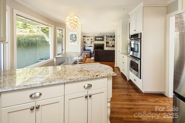 205 Midland Dr, Asheville, NC 28804 - kitchen with crown molding, white cabinetry, a fireplace, stainless steel appliances, and dark wood-style flooring
