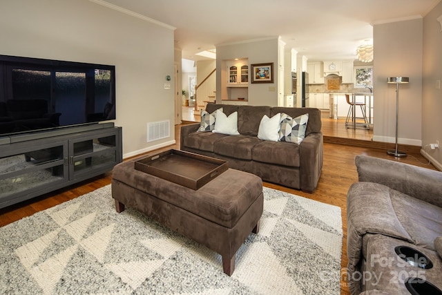 205 Midland Dr, Asheville, NC 28804 - living area with wood finished floors, ornamental molding, stairway, and visible vents