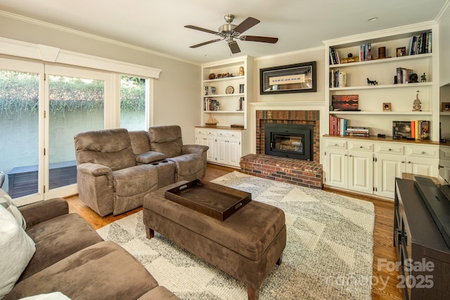 205 Midland Dr, Asheville, NC 28804 - living area with a ceiling fan, wood finished floors, crown molding, and a brick fireplace
