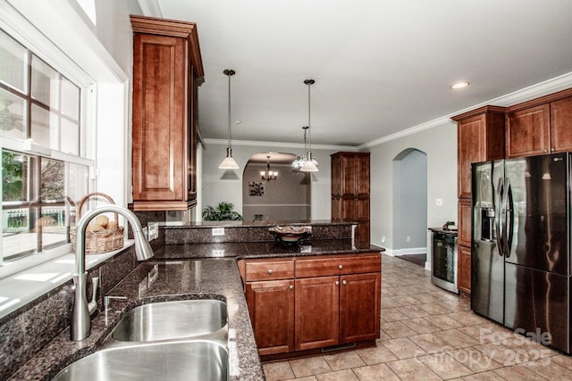 4907 White Oak Ln, Denver, NC 28037 - kitchen with fridge with ice dispenser, arched walkways, crown molding, a peninsula, and hanging light fixtures