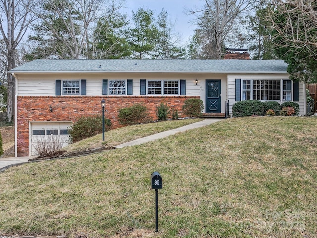 single story home with driveway, brick siding, a chimney, an attached garage, and a front yard