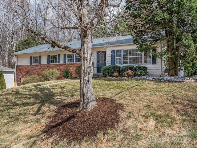 single story home featuring a front lawn and brick siding