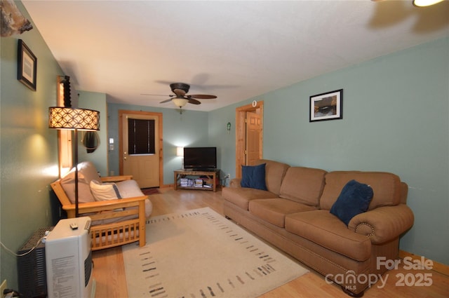 living room with ceiling fan and wood finished floors