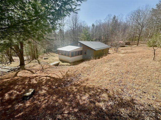 view of property exterior featuring metal roof