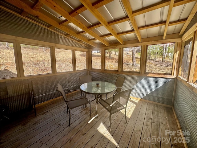 unfurnished sunroom featuring vaulted ceiling