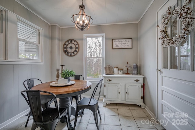 dining room with light tile patterned floors, plenty of natural light, and crown molding