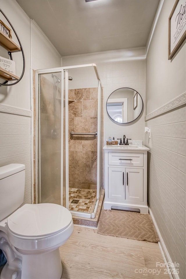 full bath with tile walls, toilet, and a stall shower