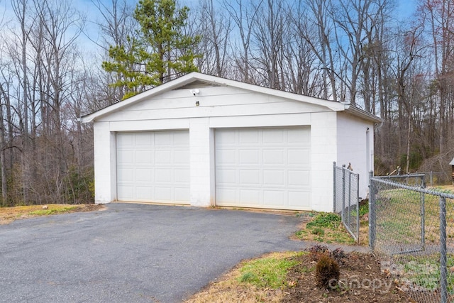 detached garage featuring fence