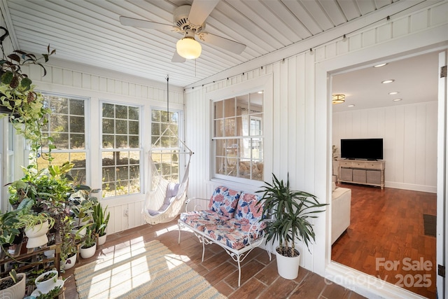sunroom with visible vents and a ceiling fan