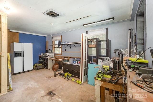 interior space with white fridge with ice dispenser