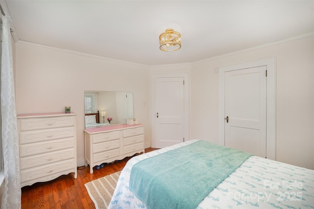 bedroom with ornamental molding and wood finished floors