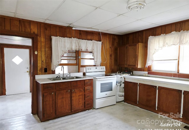 410 Cole Campbell Rd, Taylorsville, NC 28681 - kitchen featuring a sink, a drop ceiling, wood walls, light countertops, and electric stove
