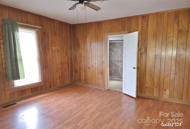 410 Cole Campbell Rd, Taylorsville, NC 28681 - unfurnished bedroom featuring wood walls, wood finished floors, and visible vents