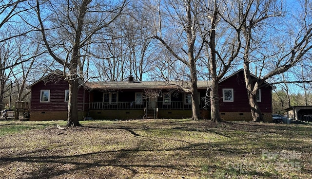 ranch-style house with crawl space, covered porch, a chimney, and roof with shingles