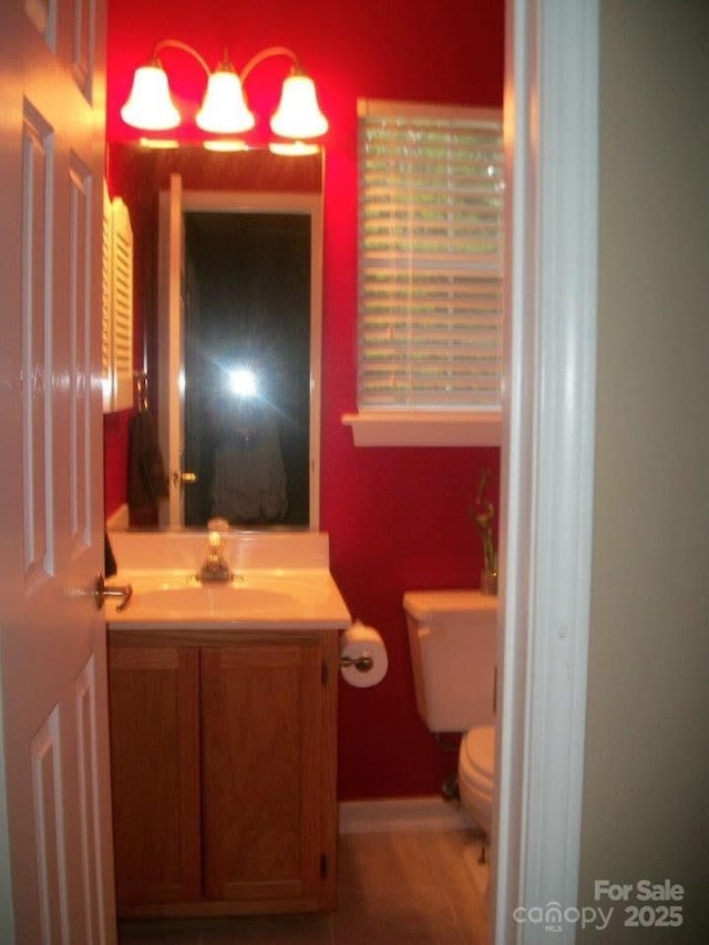 half bathroom with toilet and vanity