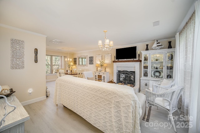 bedroom featuring a chandelier, light wood-style flooring, visible vents, baseboards, and crown molding