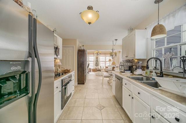 kitchen with light countertops, white cabinetry, black appliances, and light tile patterned flooring