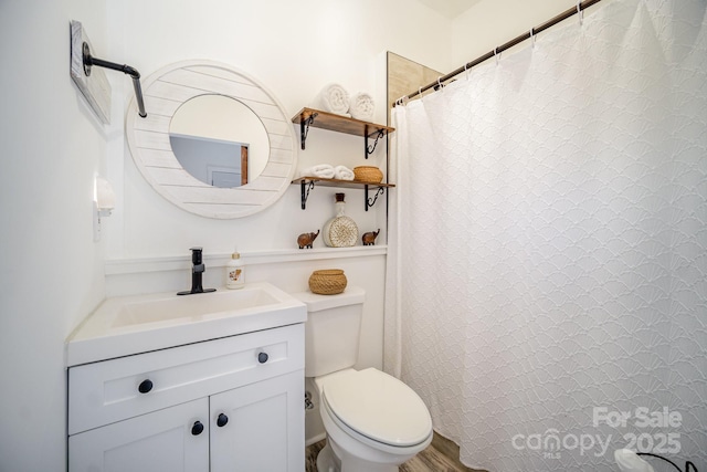 bathroom featuring toilet, a shower with curtain, and vanity