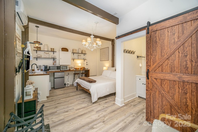 bedroom featuring light wood finished floors, a barn door, beamed ceiling, and freestanding refrigerator