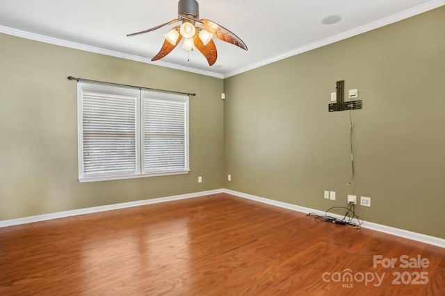 unfurnished room featuring ornamental molding, wood finished floors, baseboards, and ceiling fan