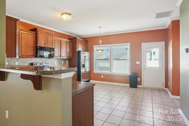 kitchen with visible vents, brown cabinets, ornamental molding, stainless steel fridge with ice dispenser, and black microwave