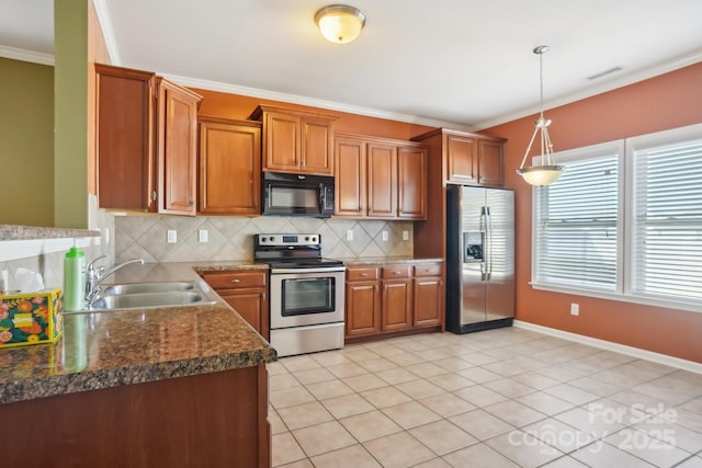 kitchen featuring crown molding, brown cabinets, appliances with stainless steel finishes, and a sink