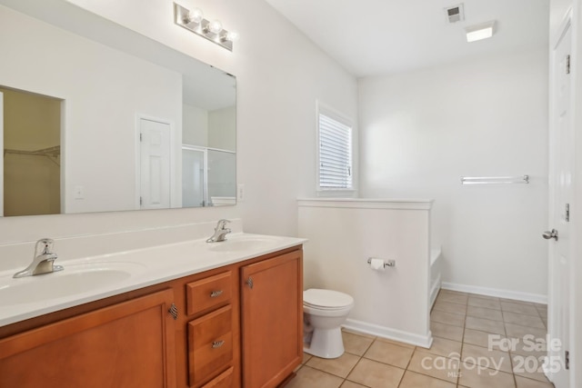 bathroom with tile patterned flooring, double vanity, visible vents, and a sink