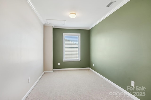 empty room with attic access, ornamental molding, visible vents, and light carpet