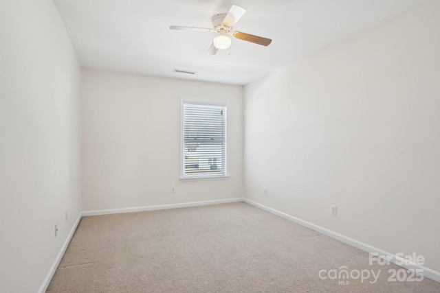 spare room featuring visible vents, baseboards, carpet, and a ceiling fan