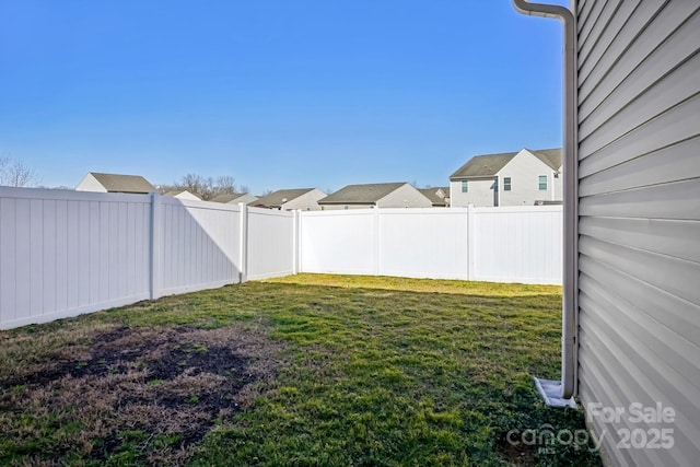 view of yard with a residential view and a fenced backyard