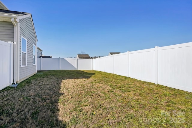 view of yard with a fenced backyard