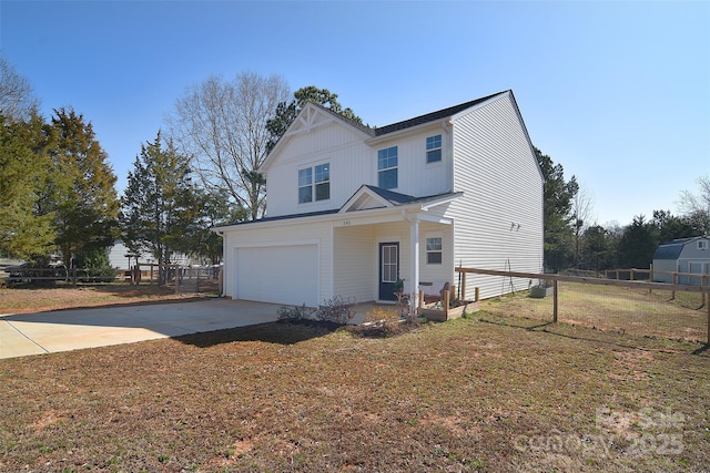 view of front of home with driveway, a garage, and fence